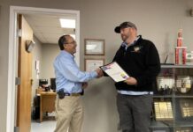 
			
				                                Fire Chief Scott Rouse, right, of Pleasant Grove Volunteer Fire & EMS, accepts the Valor Award from Brent Heath, Director of Governmental Affairs with the Office of State Fire Marshal. On June 3, Rouse — with no protective gear — rescued his elderly neighbor from a house fire. (Kathy Grant Westbrook|mountolivetribune.com)
 
			
		