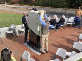 
			
				                                Simon Thornton (left) and Faison Mayor Billy Ward unveil a monument that pays tribute to Thornton’s father, William E. Thornton, a Faison native who became a physician, inventor, author, and astronaut. The monument is located on the site previously occupied by the town’s school gym and pays tribute to the school, as well. (Kathy Grant Westbrook|mountolivetribune.com)
 
			
		