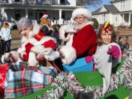 
			
				                                Cora Price, parade junior grand marshal, offers candy as she rides with Santa and Mrs. Claus Saturday during the Mount Olive Christmas Parade sponsored by the Mount Olive Area Chamber of Commerce. (Steve Herring|mountolivetribune.com)
 
			
		